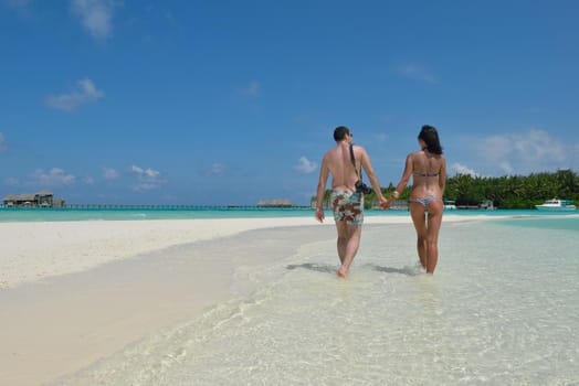 happy young romantic couple in love have fun and relaxing on beautiful beach