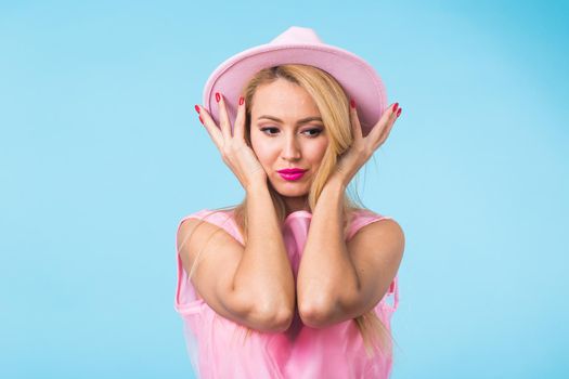 Beautiful woman with long straight blond hair. Fashion model posing at studio.