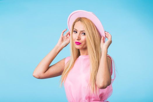 Beautiful woman with long straight blond hair. Fashion model posing at studio.