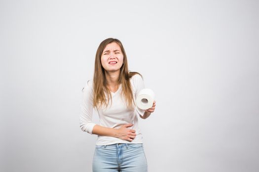 Woman with toilet paper and problems with her digestive system.