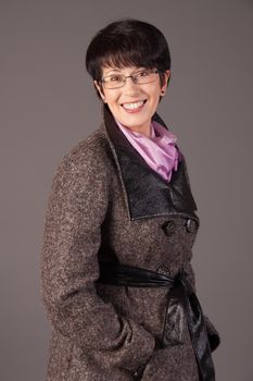 Elegant middle aged woman posing with woolen warm scarf