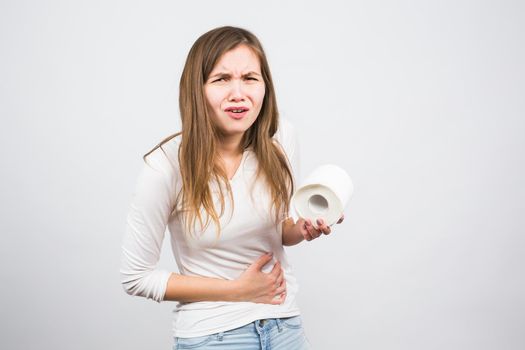 Young woman with Toilet Paper on the White Background - health problem concept.