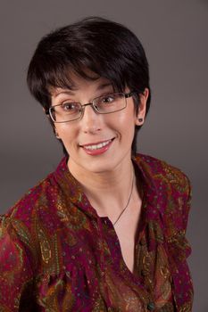 Elegant middle aged woman posing with woolen warm scarf