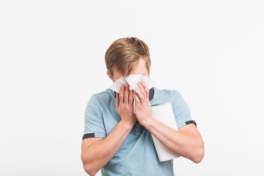 Young man with handkerchief. Sick guy isolated has runny nose