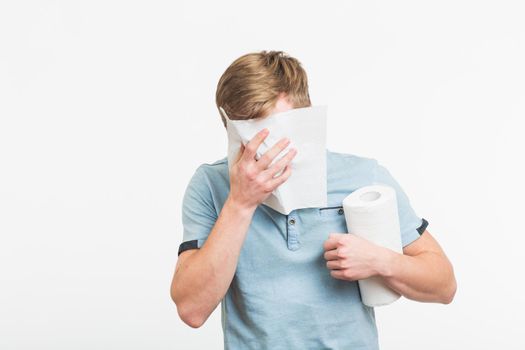 Young man with handkerchief. Sick guy isolated has runny nose