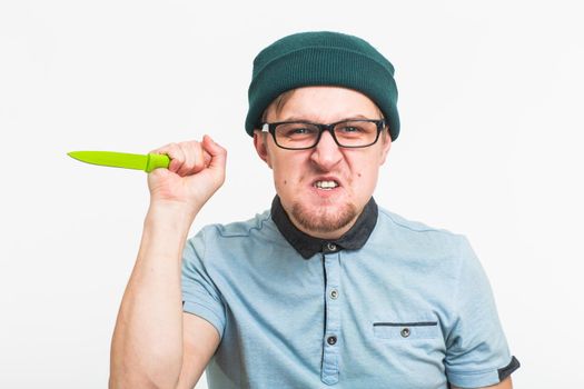 Young angry man holding a knife isolated on a white background.