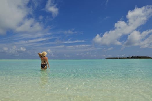 happy young woman on summer vacation on beautiful tropical beach have fun enjoy and relax