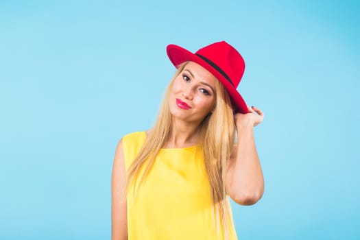 Portrait of happy cheerful smiling young beautiful blond woman on blue background.