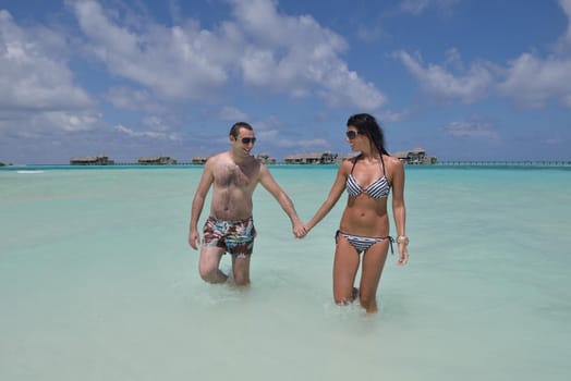 happy young romantic couple in love have fun and relaxing on beautiful beach