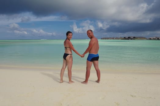 happy young romantic couple in love have fun running and relaxing on beautiful beach