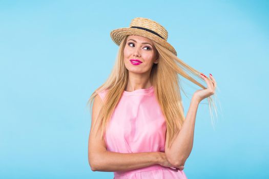 Beautiful woman with long straight blond hair. Fashion model posing at studio.