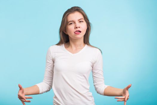 Funny beautiful young woman have fun over blue background