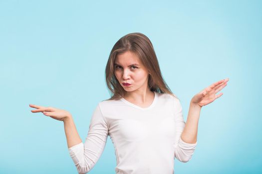 Energy girl dances on blue background in studio