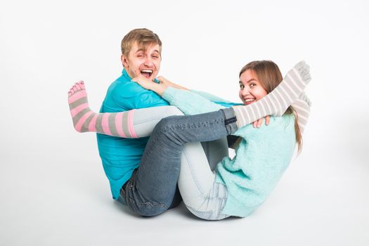 Portrait funny moments of excited couple fooling around to camera on white background. Having fun, weekends and valentines day concept.