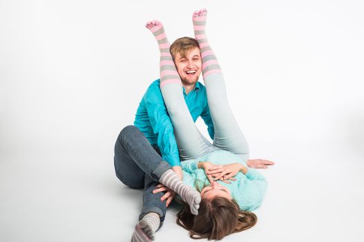 Portrait funny moments of excited couple fooling around to camera on white background. Having fun, weekends and valentines day concept.