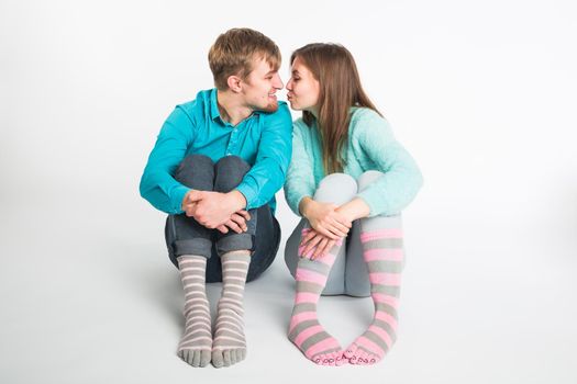 Portrait funny moments of excited couple fooling around to camera on white background. Having fun, weekends and valentines day concept.