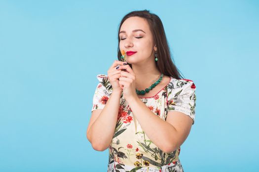 Portrait of young beautiful ginger woman with freckles cheerfuly smiling looking at camera. Isolated on pastel blue background. Copy space.