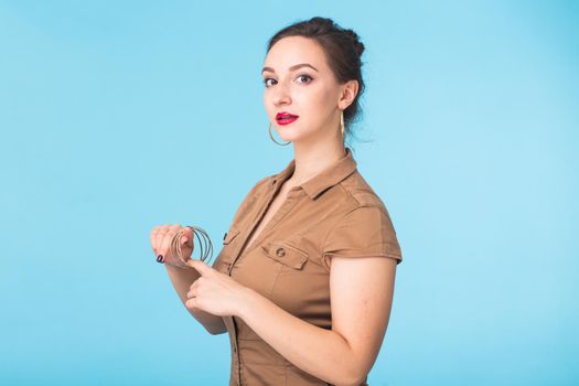 Portrait of young beautiful ginger woman with freckles cheerfuly smiling looking at camera. Isolated on pastel blue background. Copy space.