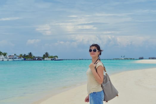 happy young woman on summer vacation on beautiful tropical beach have fun enjoy and relax