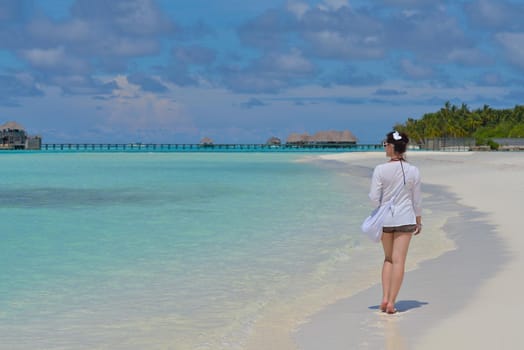 happy young woman on summer vacation on beautiful tropical beach have fun enjoy and relax