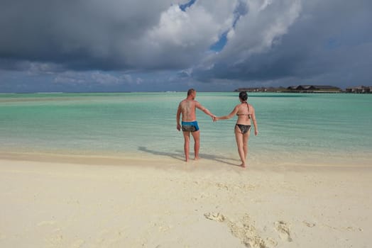 happy young romantic couple in love have fun running and relaxing on beautiful beach