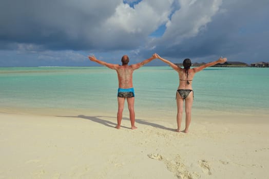 happy young romantic couple in love have fun running and relaxing on beautiful beach