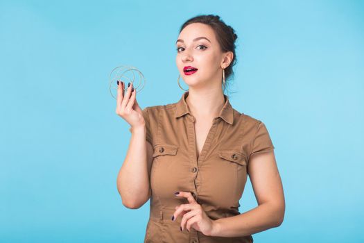 Portrait of young beautiful ginger woman with freckles cheerfuly smiling looking at camera. Isolated on pastel blue background. Copy space.