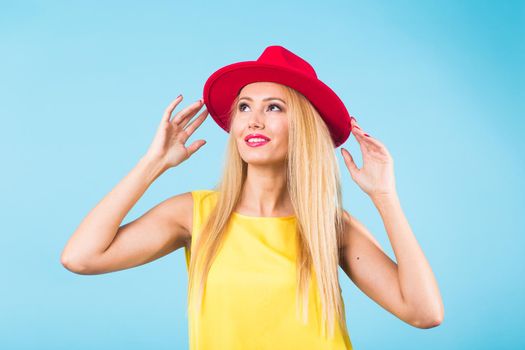 Portrait of happy cheerful smiling young beautiful blond woman on blue background.