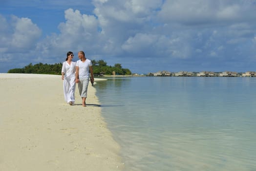 happy young romantic couple in love have fun running and relaxing on beautiful beach