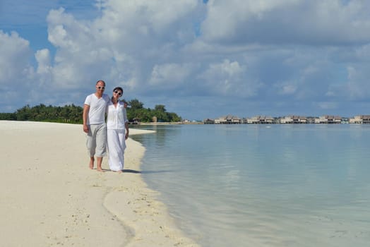 happy young romantic couple in love have fun running and relaxing on beautiful beach