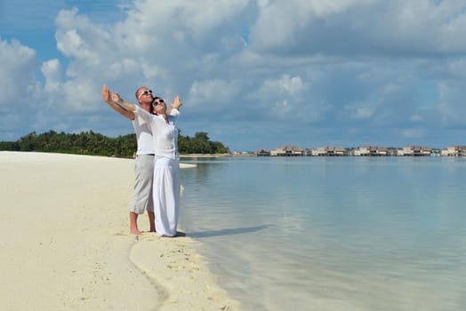 happy young romantic couple in love have fun running and relaxing on beautiful beach