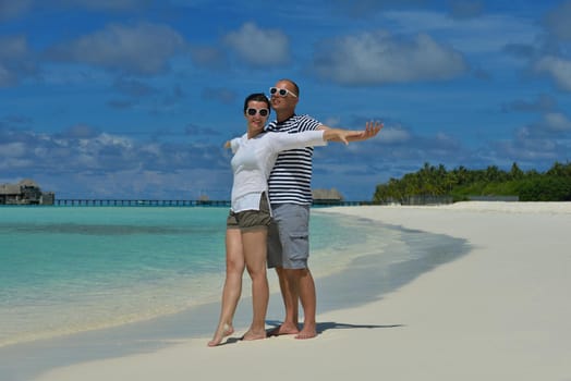 happy young romantic couple in love have fun running and relaxing on beautiful beach