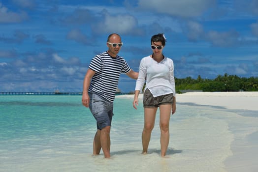 happy young romantic couple in love have fun running and relaxing on beautiful beach