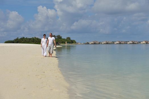 happy young romantic couple in love have fun running and relaxing on beautiful beach