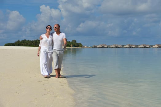 happy young romantic couple in love have fun running and relaxing on beautiful beach