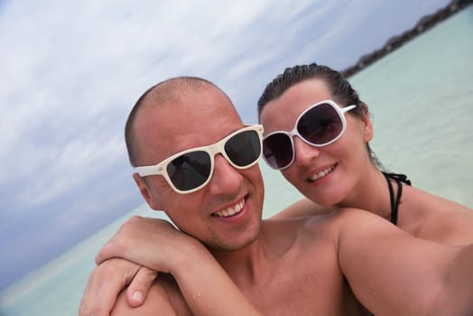 happy young  couple at summer vacation have fun and relax at beautiful sunny  day on beach