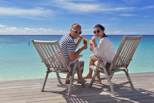 happy young couple relax and take fresh drink at summer vacation