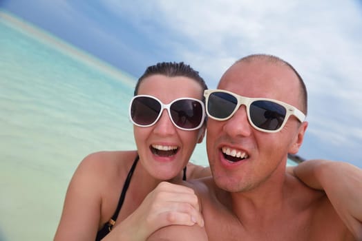 happy young  couple at summer vacation have fun and relax at beautiful sunny  day on beach