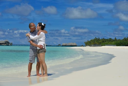 happy young romantic couple in love have fun running and relaxing on beautiful beach