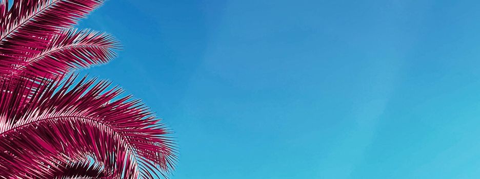 Pop art and tropical nature concept. Red palm tree leaves and blue sky as vintage summer background.