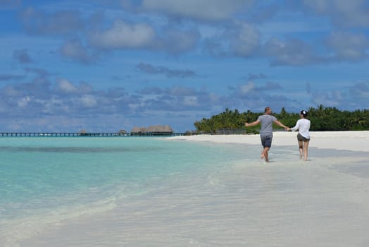 happy young  couple at summer vacation have fun and relax at beautiful sunny  day on beach