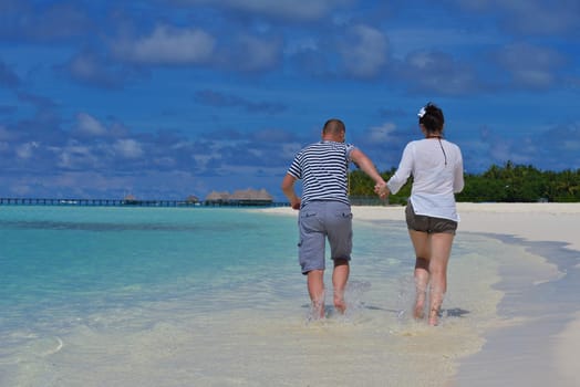 happy young  couple at summer vacation have fun and relax at beautiful sunny  day on beach