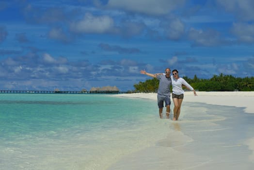 happy young romantic couple in love have fun running and relaxing on beautiful beach