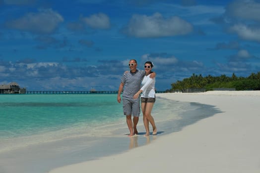 happy young romantic couple in love have fun running and relaxing on beautiful beach