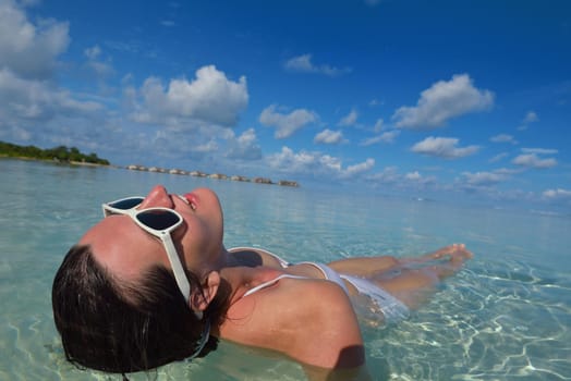 happy young woman on summer vacation on beautiful tropical beach have fun enjoy and relax