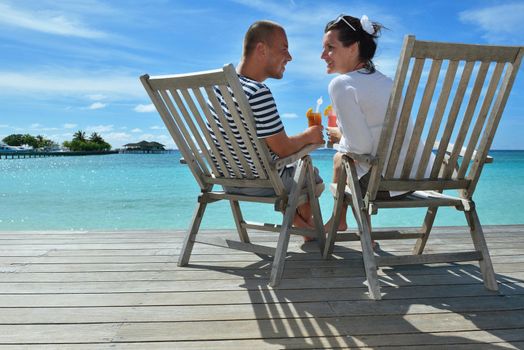 happy young couple relax and take fresh drink at summer vacation