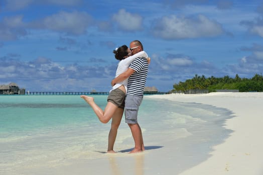 happy young  couple at summer vacation have fun and relax at beautiful sunny  day on beach