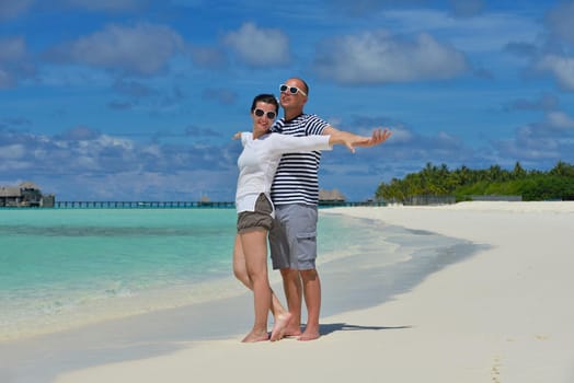 happy young  couple at summer vacation have fun and relax at beautiful sunny  day on beach