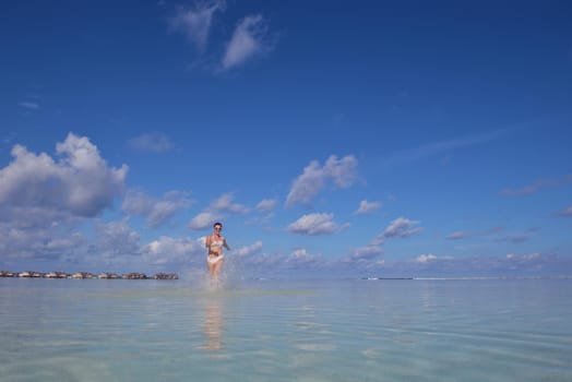 happy young woman on summer vacation on beautiful tropical beach have fun enjoy and relax