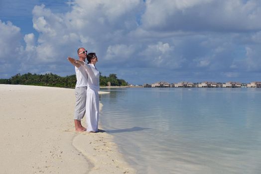 happy young  couple at summer vacation have fun and relax at beautiful sunny  day on beach